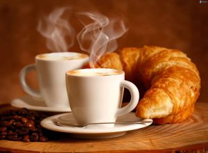 croissant beside a steaming cup| Image credit: lesarrazin.ch